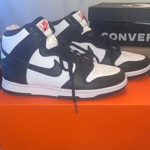 Woman’s black and white Nike panda dunks